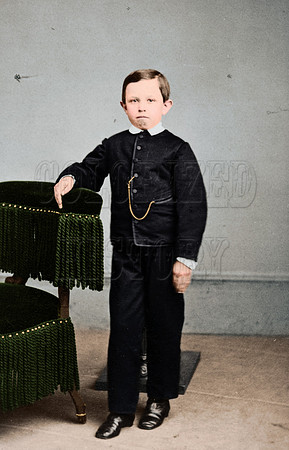 Tad Lincoln, standing, leaning against a chair