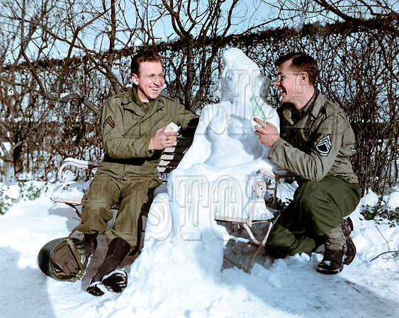 Corporal Bernard Butnik, Cleveland Heights, Ohio, and Sergeant Richard Goodbar, Russellville, Arkansas, offer Agnes cigarettes and a coke. European Theater, January 14, 1945
